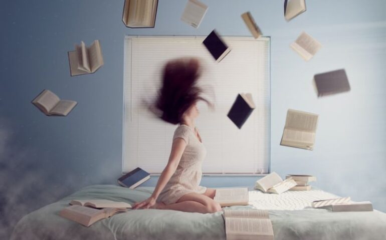 lady on the bed with books