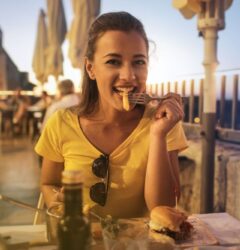 woman in yellow shirt with food