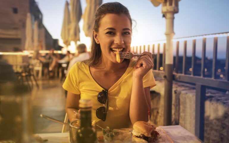 woman in yellow shirt with food